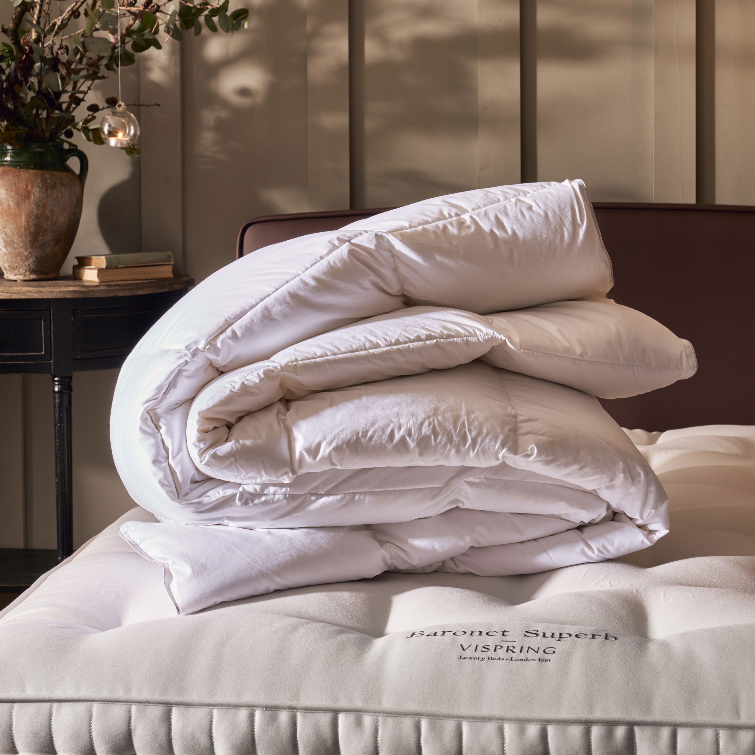 A folded duvet on a bare mattress