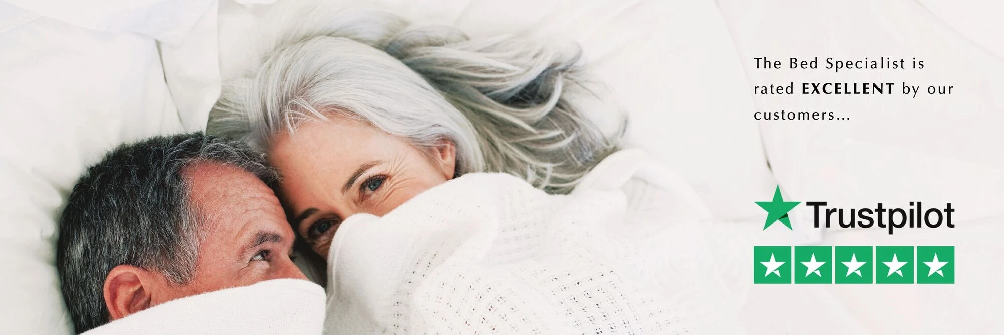 Couple lying under quilt